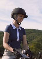 Woman riding a horse with mountains in the background